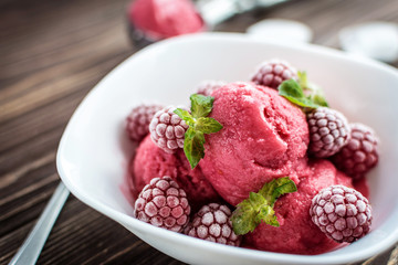 Delicious ice cream  made from fresh berries on a wooden background