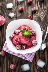 Delicious ice cream  made from fresh berries on a wooden background