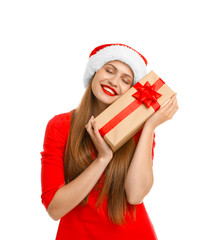 Young beautiful woman in Santa hat with gift box on white background. Christmas celebration