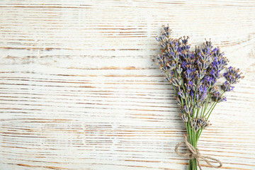 Blooming lavender flowers on wooden background, top view