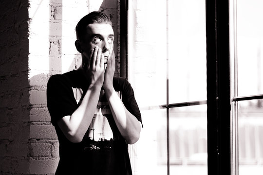 Portret of a handsome white eyes young neformal white guy with tonels