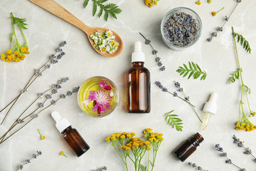 Flat lay composition with essential oils and flowers on light background - obrazy, fototapety, plakaty