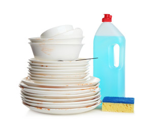 Pile of dirty kitchenware, dish detergent and sponge on white table