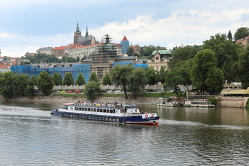 Naklejka premium Striking view from the Charles Bridge to the Vltava river, old architecture and modernity
