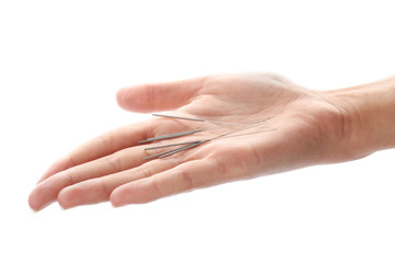 Woman holding needles for acupuncture on white background