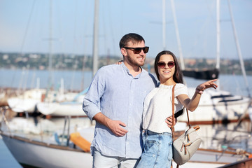 Young hipster couple in jean clothes on pier