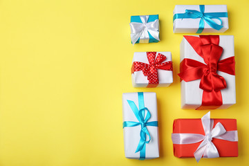 Flat lay composition with gift boxes on color background