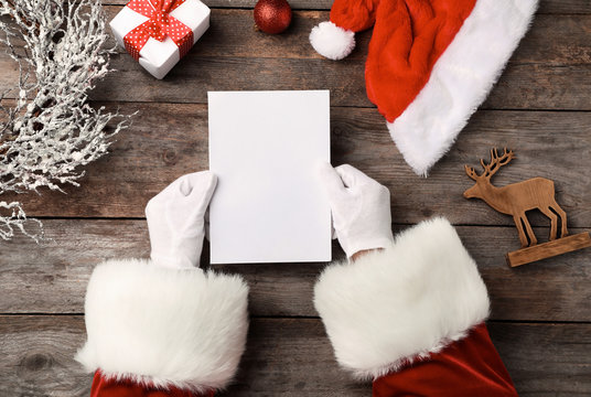 Santa Claus Reading Letter From Child At Table, Top View. Christmas Celebration