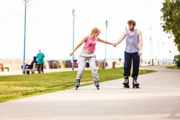 Fototapeta premium Active young people friends rollerskating outdoor.