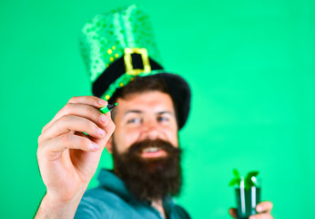 St Patricks day. Close up portrait of happy bearded man in leprechaun hat with green marker....