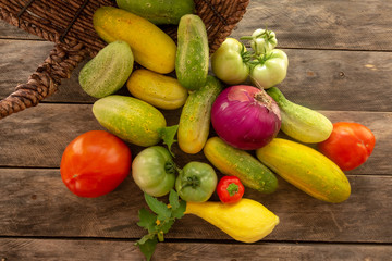 Garden fresh squash cucumber tomato onion pepper with background copy space