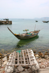 Traditional fishing boat and a raft on an vietnamese island