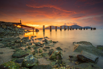 Fototapeta na wymiar Beautiful view of sunset at Marina Island Old Jetty,Malaysia. Soft Focus, Image Blur due to long exposure. Visible noise due to high ISO.