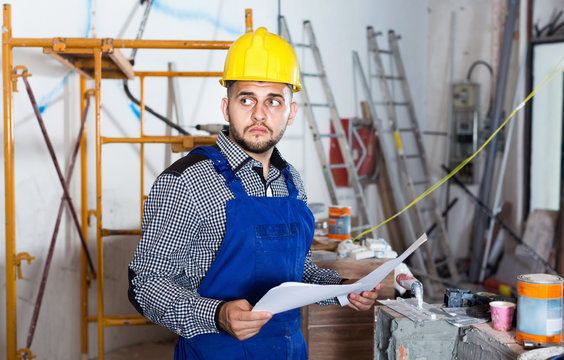 Builder is looking on the project of work