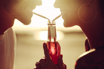 Loving couple sharing a soft drink