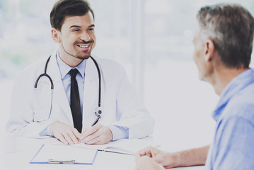 Handsome Smart Male Doctor Talking with Patient
