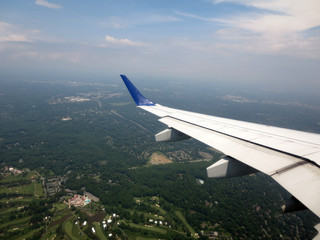 airplane wing as it flies into city