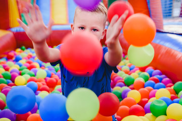 Fototapeta na wymiar Inflatable castle full of colored balls for children to jump