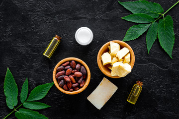 Beautiful composition with cocoa butter cosmetics. Cocoa butter and cocoa beans near soap, cream,...