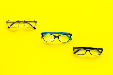 Glasses concept. Set of glasses with different eyeglass frame and transparent lenses on yellow...