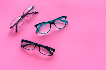 Glasses concept. Set of glasses with different eyeglass frame and transparent lenses on pink...