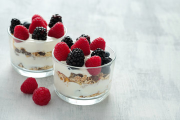 Breakfast with oat flakes, cream and fresh berries