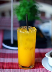 Glass of orange juice during breakfast with selective focus