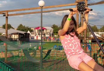 background. defocus. beautiful girl is playing on the playground. rope town.