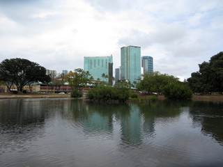 Fototapeta na wymiar Pond in Ala Moana Beach Park with Condominiums towers across the street