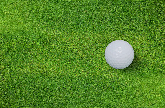 Golf ball on green grass of golf course. Golf sport background.