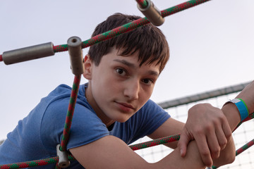background. defocus. The handsome guy has fun in a rope park.