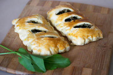 Buns of puff pastry with sorrel close-up. Tasty homemade cakes with greens
