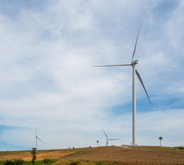 Fototapeta premium Landscape Wind turbines generating electricity with blue sky and mountain