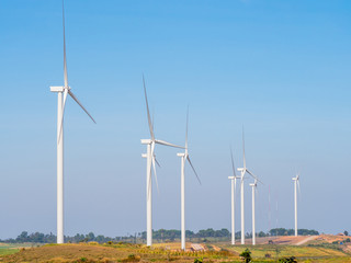 Landscape Wind turbines generating electricity with blue sky and mountain