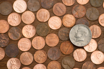 Silver dollar coin on top of pennies