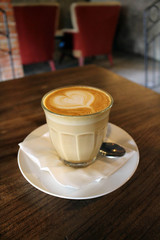 A cup of hot cafe latte (plus its latte art)