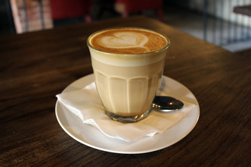 A cup of hot cafe latte (plus its latte art)