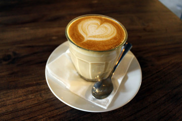 A cup of hot cafe latte (plus its latte art)