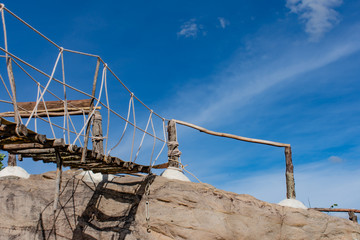 Wooden bridge on the rocks and a beautiful sky at Chaiyaphum in Thailand.