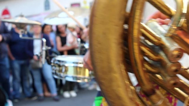 unrecognizable women playing tuba in with blurry drummer in the background during fête de la musique in Paris France