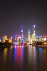 Fototapeta na wymiar Vertical photo - Shanghai, China - December 24, 2017: Shanghai Skyline at night - long exposure - radiant reflection