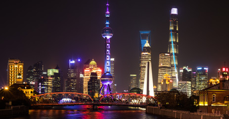 Fototapeta na wymiar Vertical photo - Shanghai, China - December 24, 2017: Shanghai Skyline at night - Waibaidu bridge, TV Pearl tower, financial buildings complete