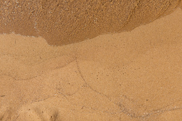 Fototapeta na wymiar Overhead shot of sand with waves lines
