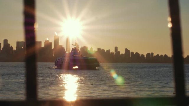Sunsetting through city skyline as friends in fishboat enjoy the harbor view