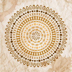 Vector abstract ethnic mandala motif on a grunge background.