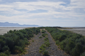 Down the dry dirt road off into the empty salt land of the great salt lake. 
