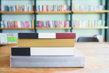 Many book stack on wooden table in library room or home office. Business , education and back to school concept.