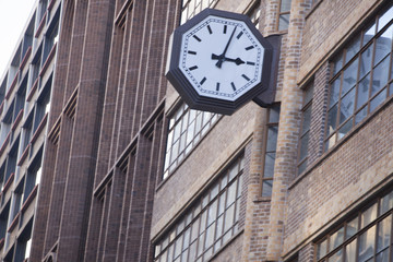 Fototapeta na wymiar Clock face on side of building