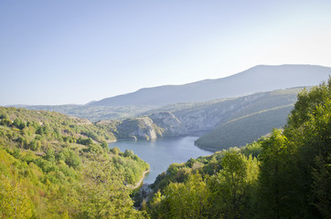 Fototapeta na wymiar The open valley and soft calm river in the Croatian mountain sides