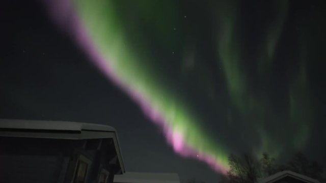 Real Time Northern Lights Behind Cabins In Finland